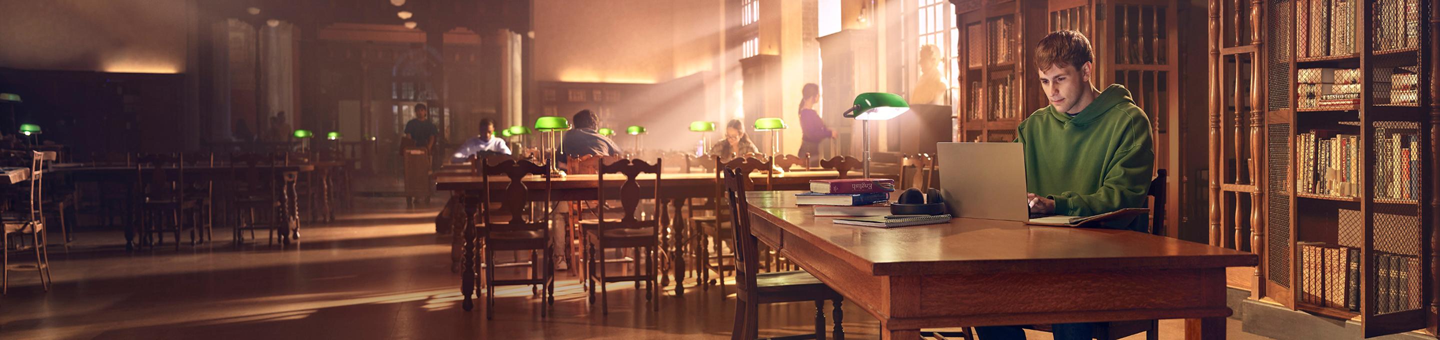 Tyler, a real patient, studying in a library.