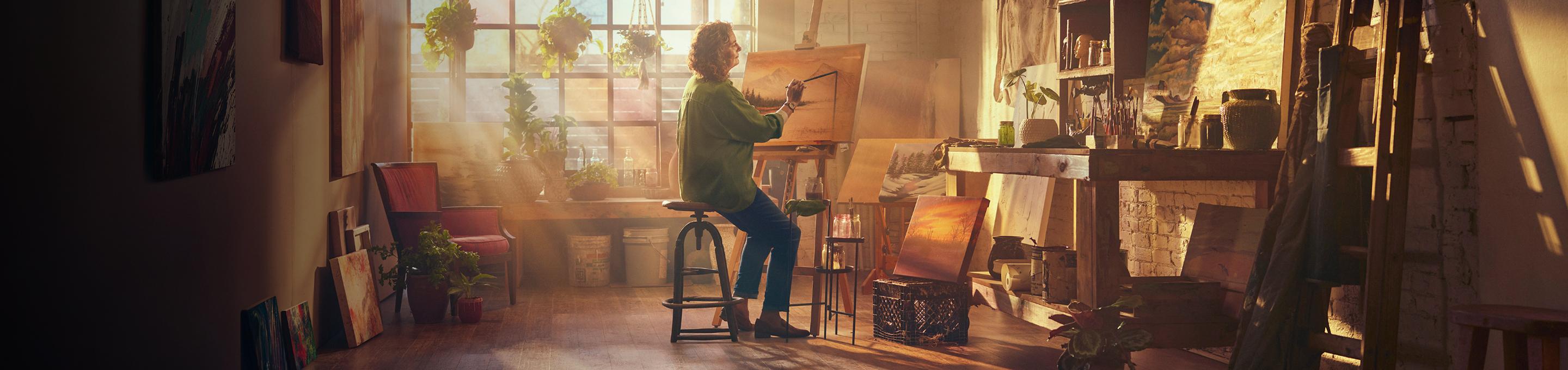 Wendy, a real patient, painting in a studio.